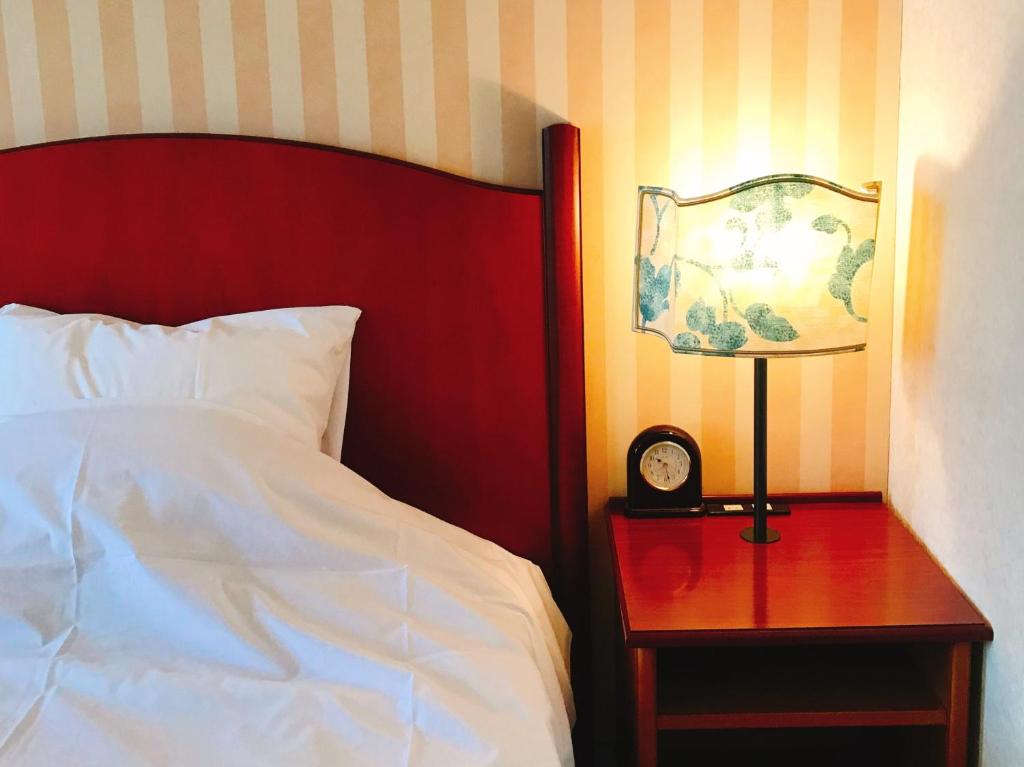 Postel nebo postele na pokoji v ubytování Kitabiwako Hotel Grazie