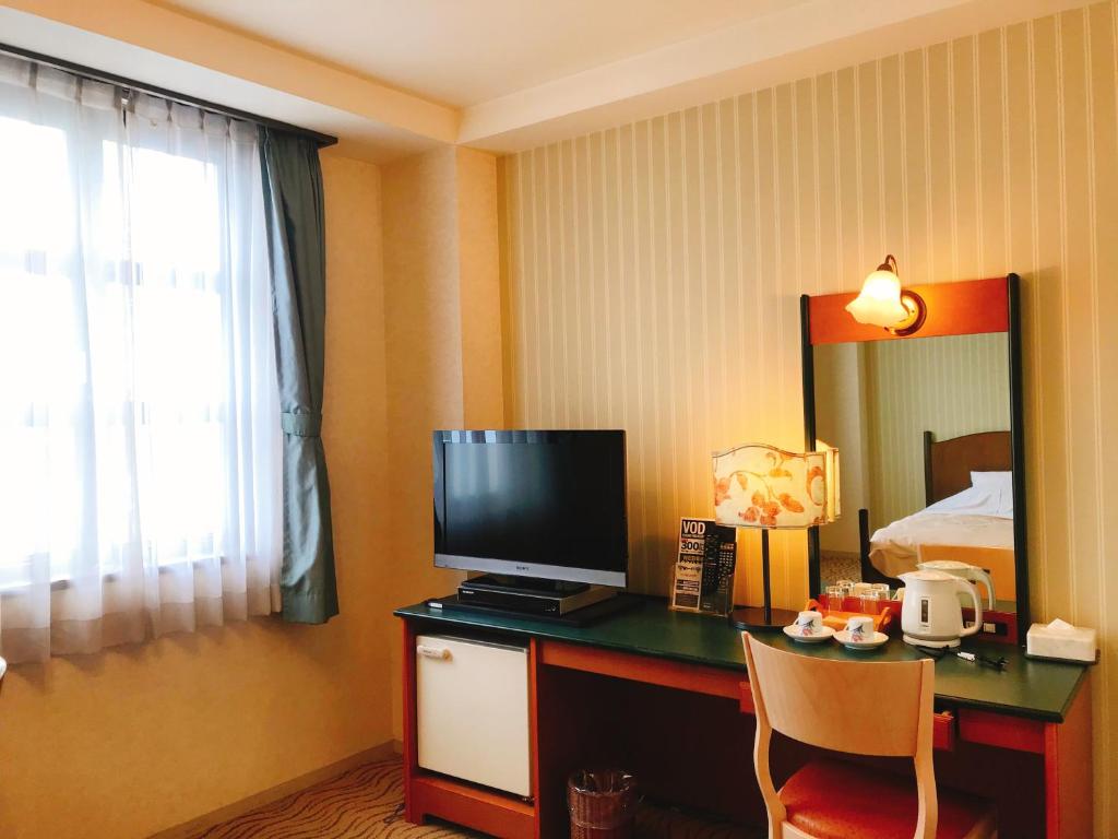TV a/nebo společenská místnost v ubytování Kitabiwako Hotel Grazie