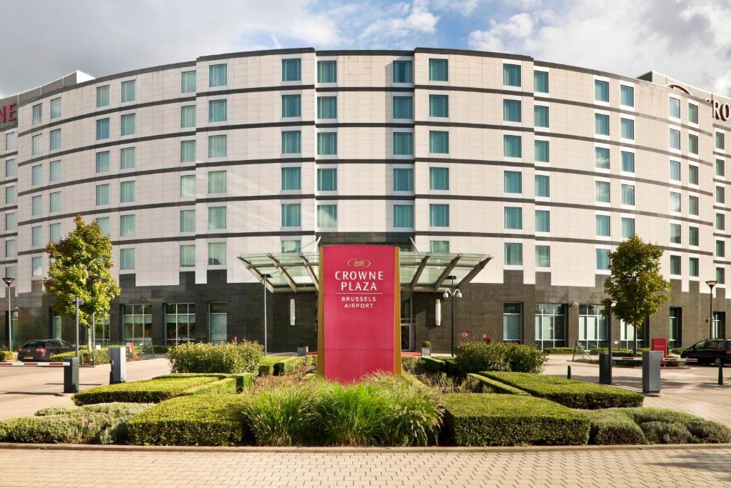 
a large building with a clock on the front of it at Crowne Plaza Brussels Airport, an IHG Hotel in Zaventem
