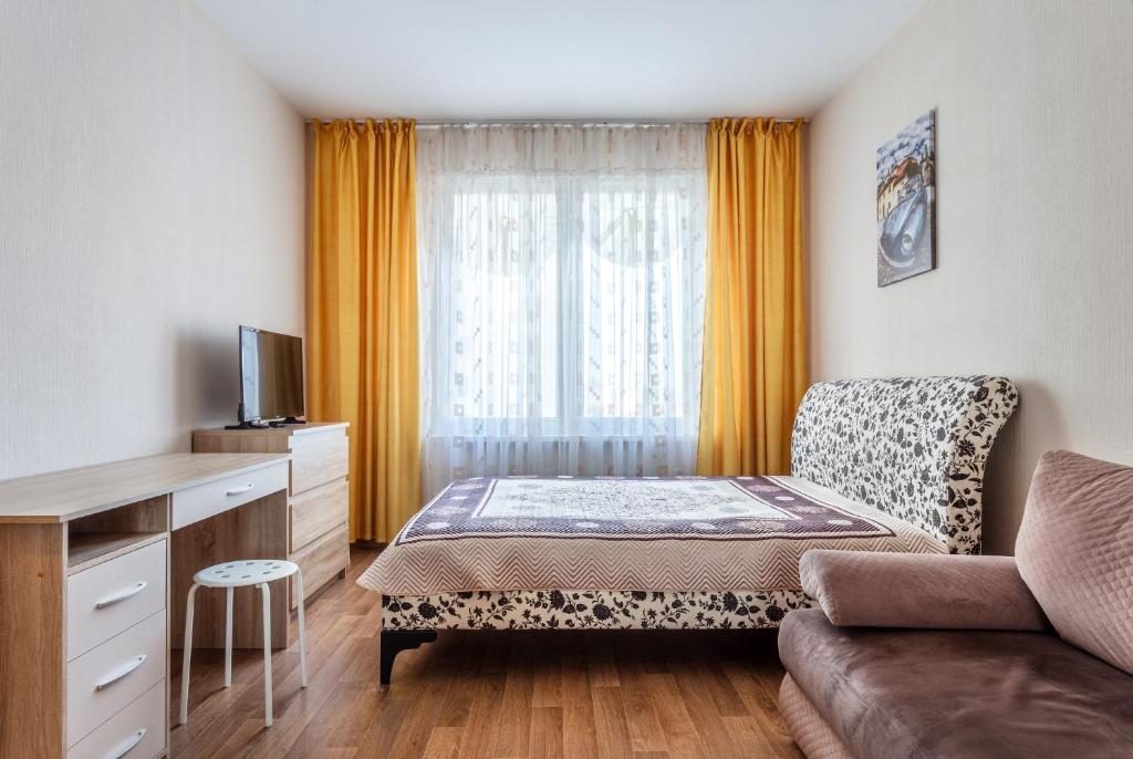 a small room with a bed and a couch at #Go2SPB - STARS View Apartment SOFIA in Saint Petersburg