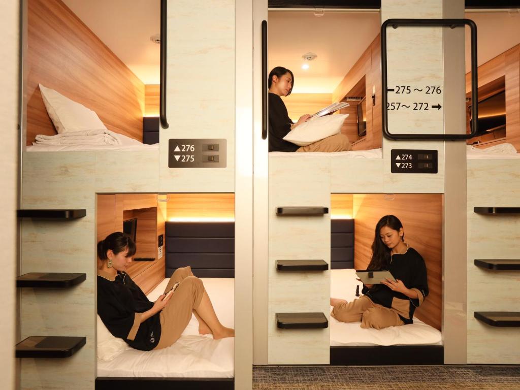 Postel nebo postele na pokoji v ubytování Smart Stay SHIZUKU Ueno Ekimae