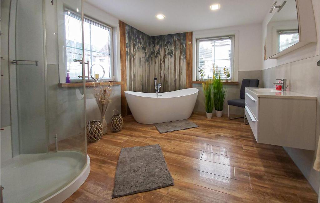 a bathroom with a tub and a sink and a toilet at Gorgeous Home In Steinheid With House A Panoramic View in Steinheid