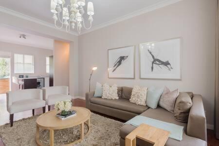 a living room with a couch and a table at Modern Apartment in Rosebank in Johannesburg