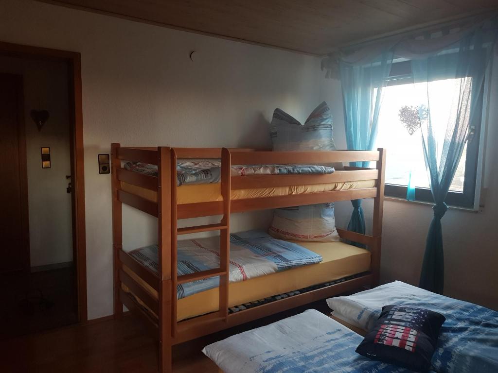 two bunk beds in a room with a bed at Ferienwohnung Parkblick Medebach in Medebach