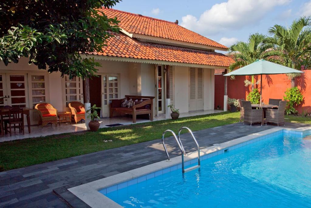 a swimming pool in front of a house at Villa Diamond in Yogyakarta