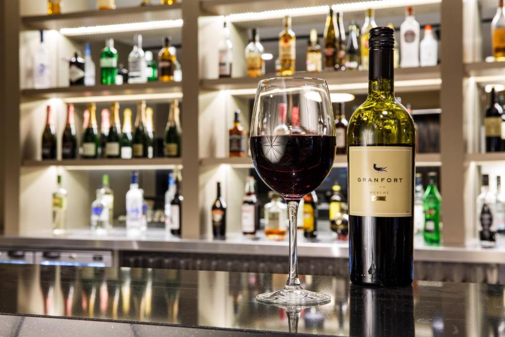 a bottle of wine sitting next to a wine glass at Crowne Plaza Aberdeen Airport by IHG in Dyce