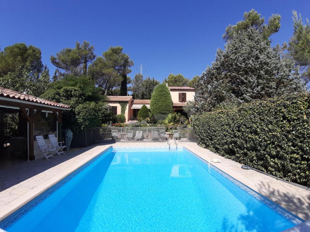 a swimming pool in front of a house at les chambres de Rocbaron in Rocbaron