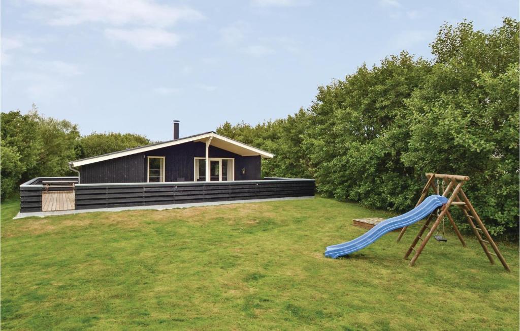 a house with a blue slide in front of it at 3 Bedroom Nice Home In Fan in Fanø