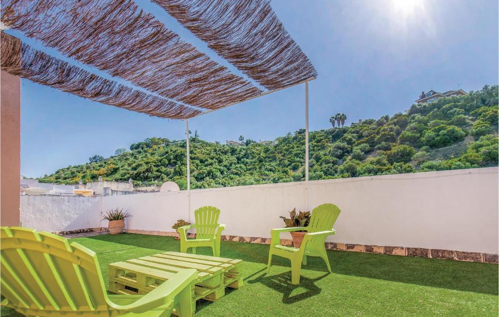 a patio with chairs and a table and a mountain at 3 Bedroom Stunning Home In Gelves in Gelves