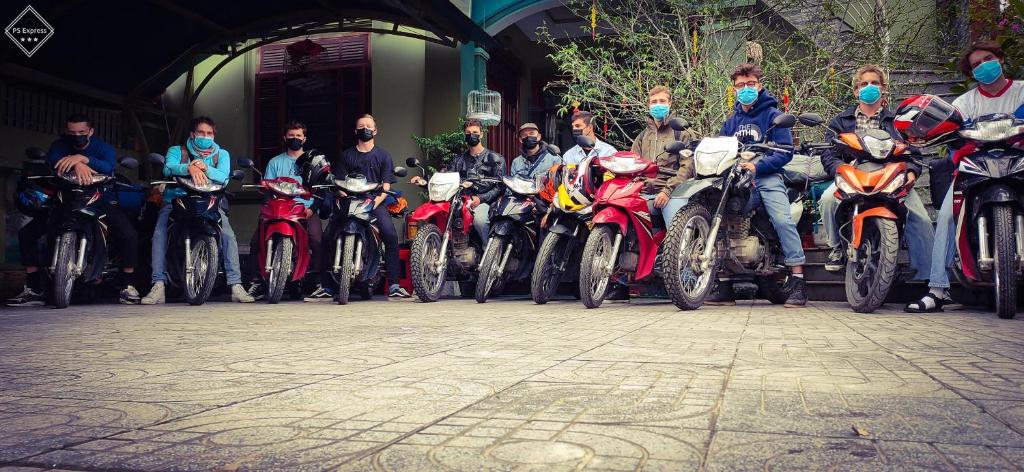 a group of people on motorcycles parked in a row at Backpackers Hotel in Hà Tĩnh