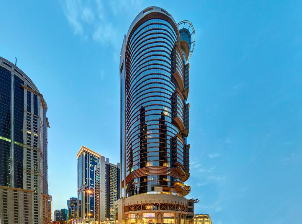 a tall building in a city with tall buildings at Crowne Plaza Doha West Bay, an IHG Hotel in Doha