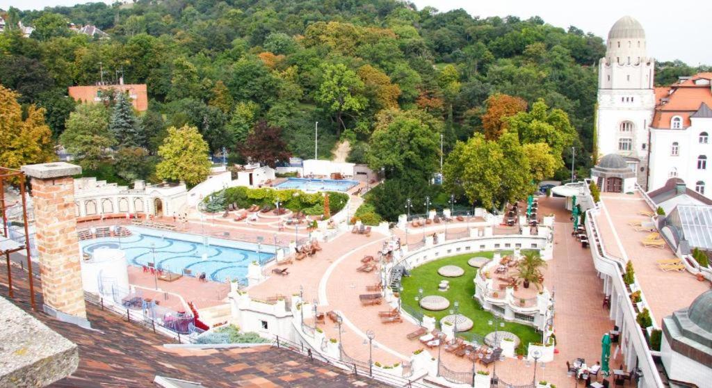 a view of a park with a swimming pool at I Love Spa in Budapest
