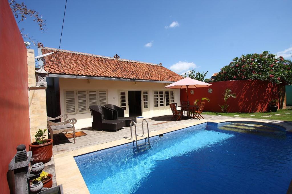 a swimming pool in front of a house at Villa Pearl in Yogyakarta