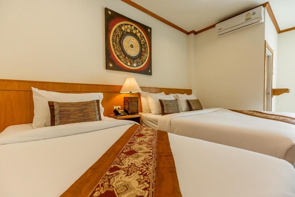 Postel nebo postele na pokoji v ubytování Loei Village Hotel