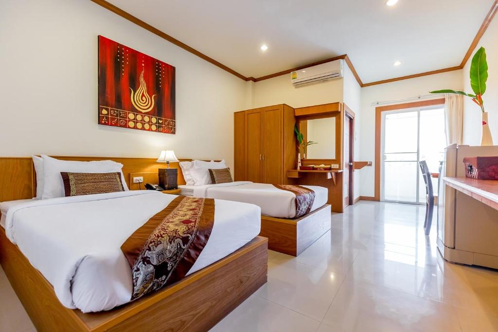 Postel nebo postele na pokoji v ubytování Loei Village Hotel