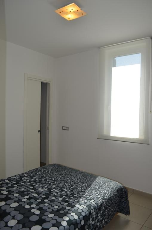 A bed or beds in a room at White Dream Spotorno