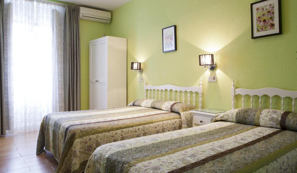 Postel nebo postele na pokoji v ubytování Hostal Los Alpes