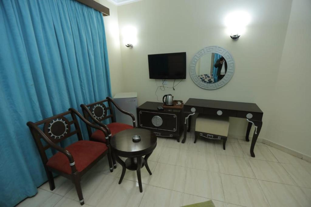 A television and/or entertainment centre at La Sirena Hotel & Resort - Families only