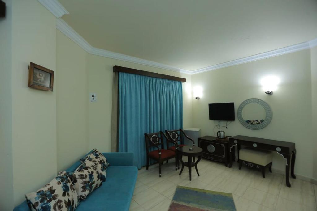 A television and/or entertainment centre at La Sirena Hotel & Resort - Families only