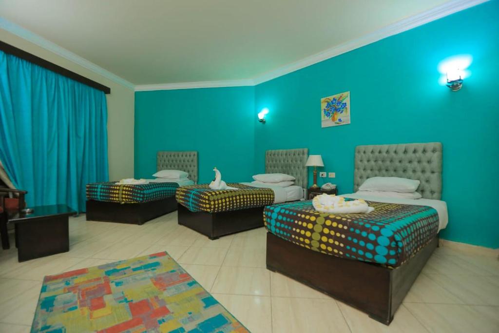 A bed or beds in a room at La Sirena Hotel & Resort - Families only