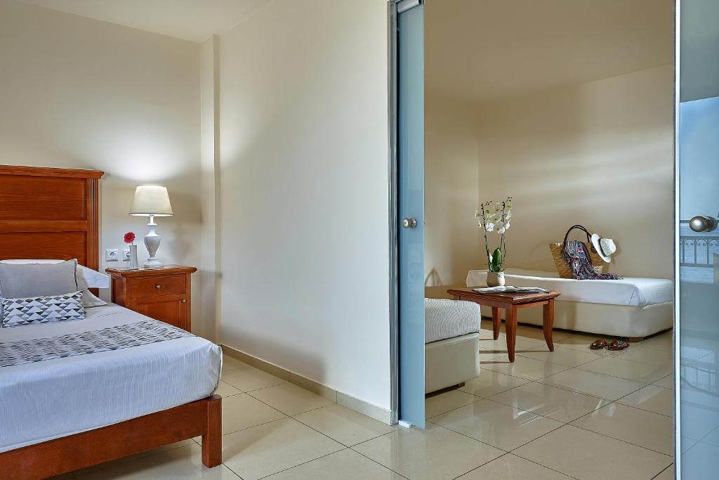a bedroom with a bed and a living room at Vasia Resort & Spa in Sisi