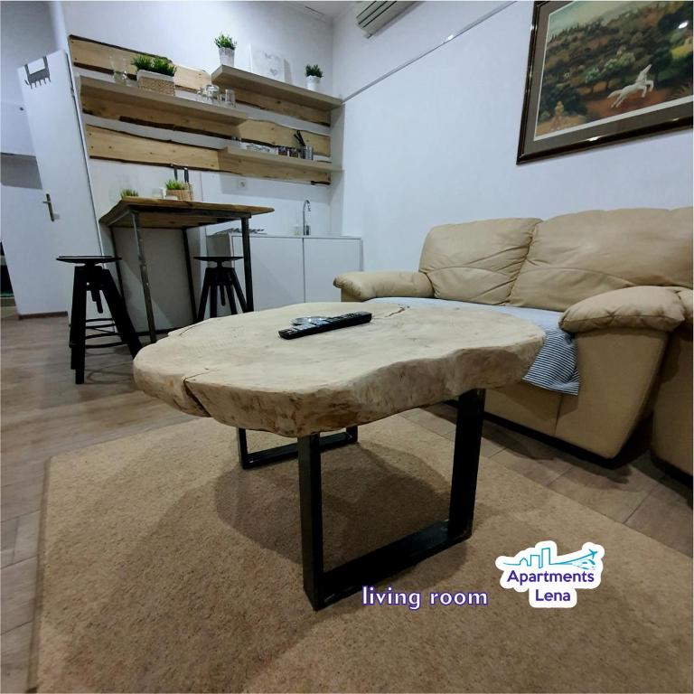 a living room with a couch and a coffee table at Apartment Lena Centar - best value, best choice! in Osijek
