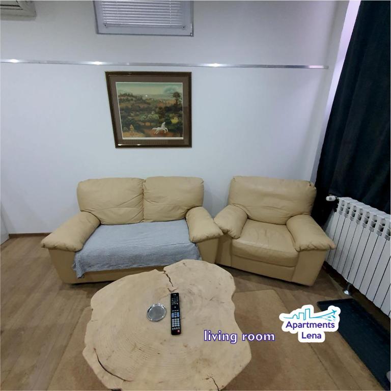 a living room with a couch and a coffee table at Apartment Lena Centar - best value, best choice! in Osijek