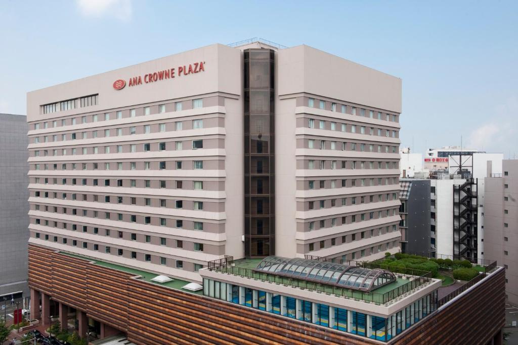 a large white building with a sign on it at ANA Crowne Plaza Fukuoka, an IHG Hotel in Fukuoka