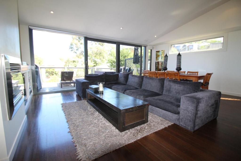 a living room with a couch and a coffee table at Lorne Holiday House in Lorne