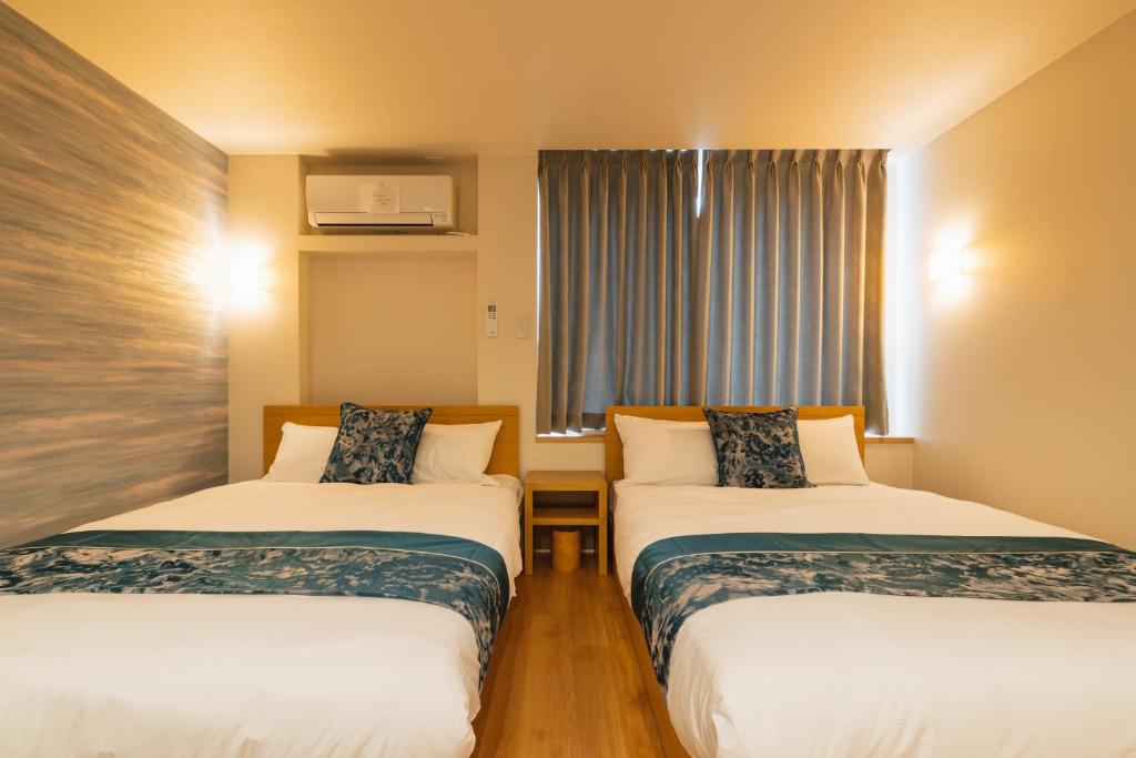 Postel nebo postele na pokoji v ubytování GRAND BASE Nagasaki City