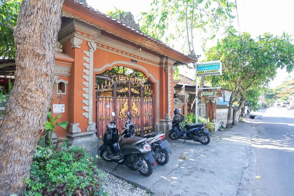 two motorcycles parked in front of a building at Gina's guest house in Sanur
