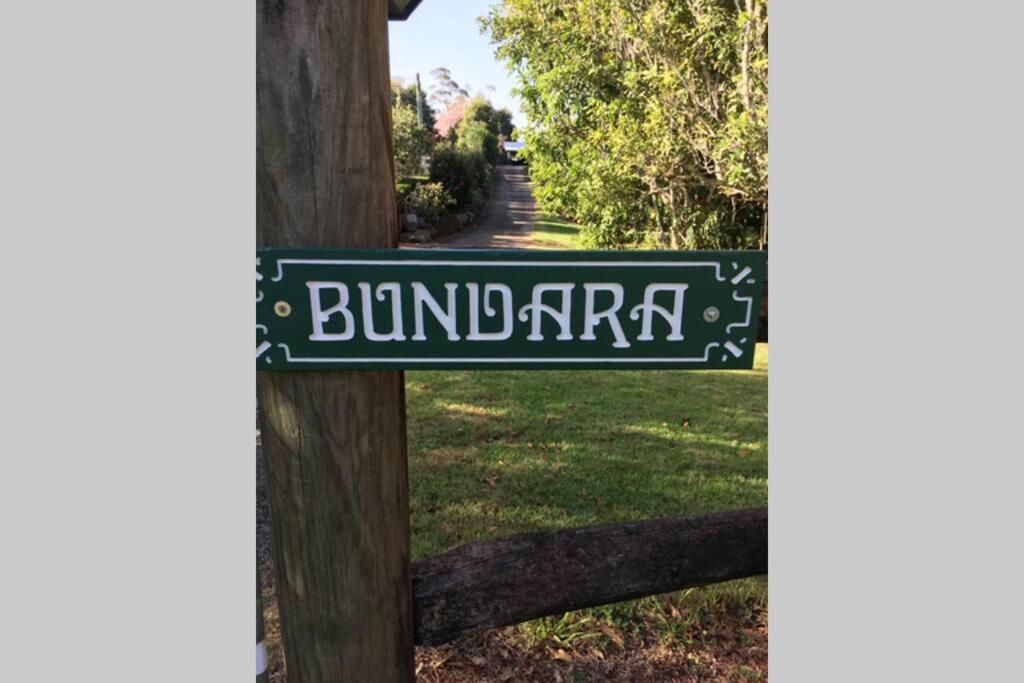 a street sign on a wooden pole at Bundara - Idyllic Getaway in the Mountains in Mount Tamborine