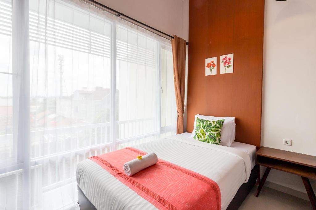 Una cama o camas en una habitación de Omah Manis
