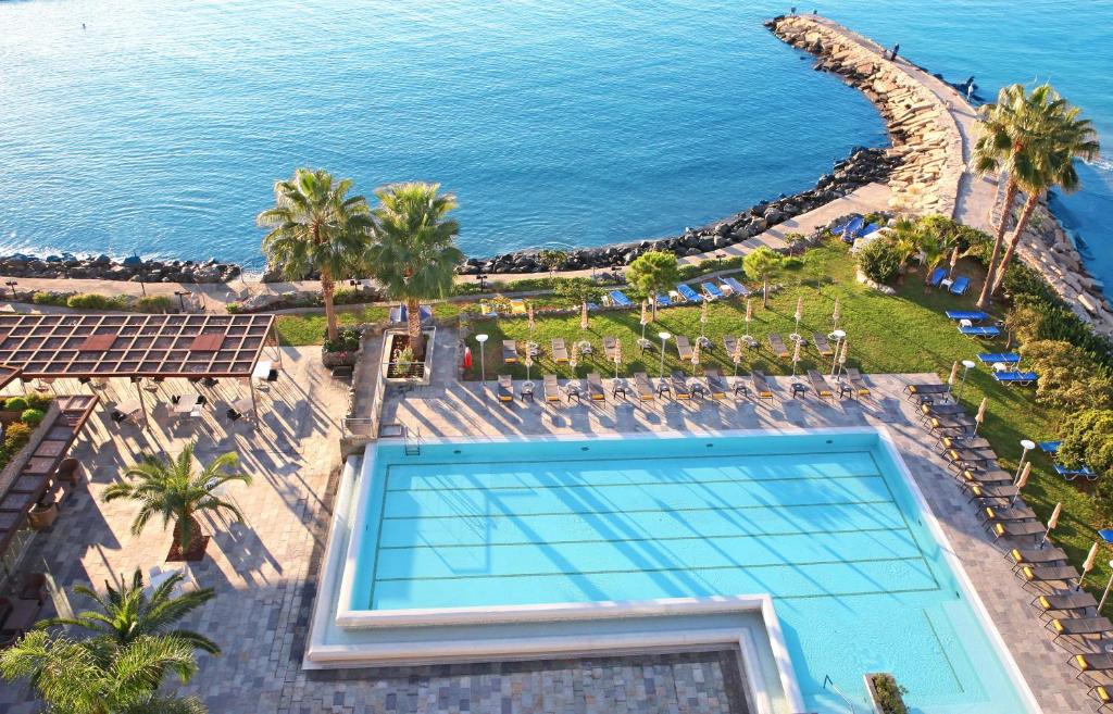 an overhead view of a swimming pool next to the ocean at Crowne Plaza Limassol by IHG in Limassol