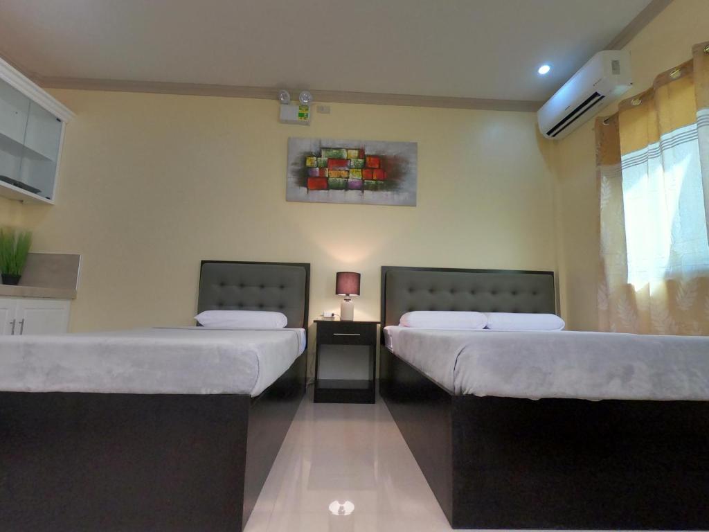 Postel nebo postele na pokoji v ubytování Mifaña Suites - Panglao Island