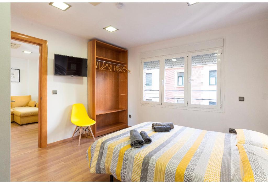Postel nebo postele na pokoji v ubytování Ílios Soho Apartamentos