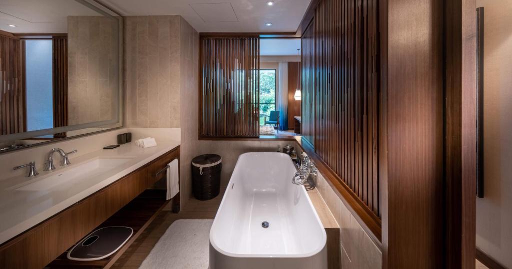 a bathroom with a bath tub and a sink at Hard Rock Hotel Desaru Coast in Desaru