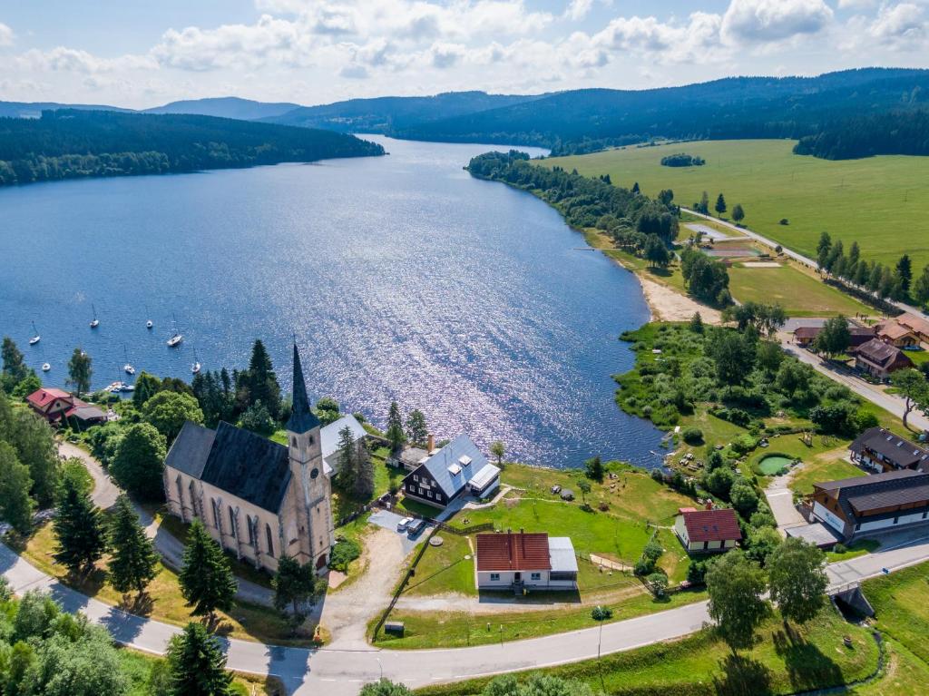 an aerial view of a town and a lake at Marvelous lake view apartments - Jezerka Lipno in Přední Výtoň