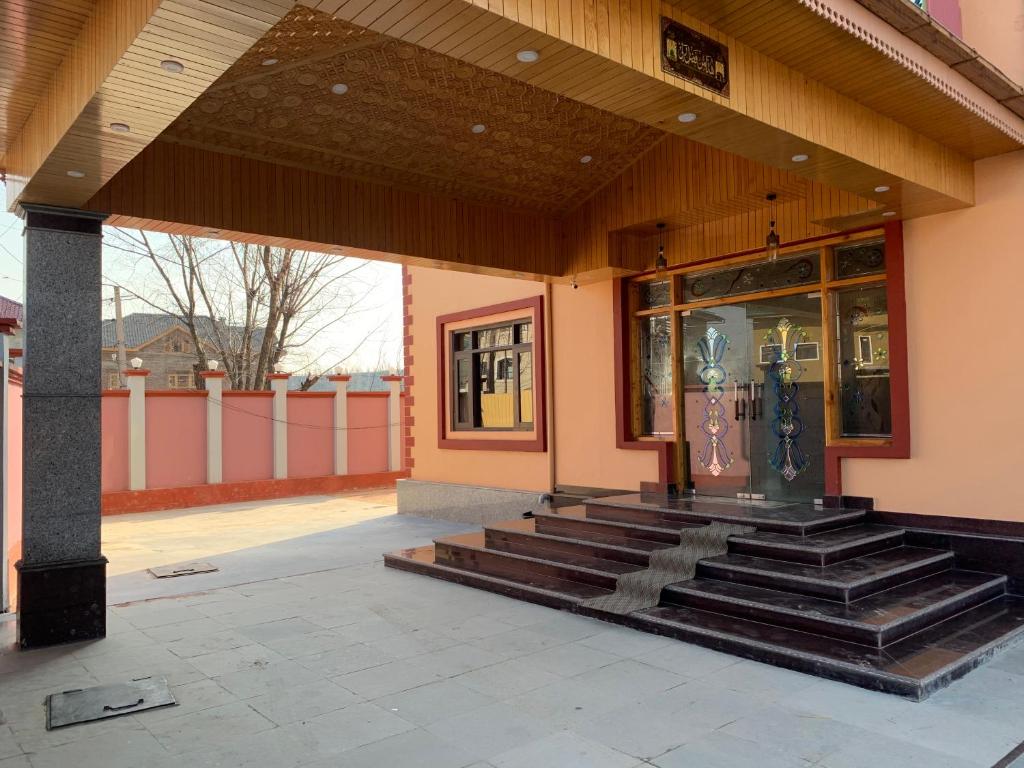 a building with stairs in front of a store at Hotel Shuhrah-I-Afaq - Near Srinagar Airport in Baghwānpur