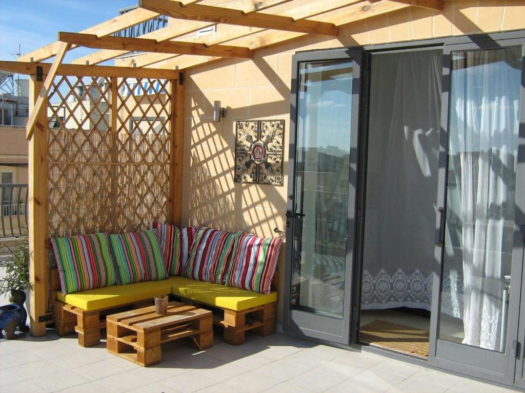 a pergola with a couch on a patio at Apartment in Marsaskala in Marsaskala