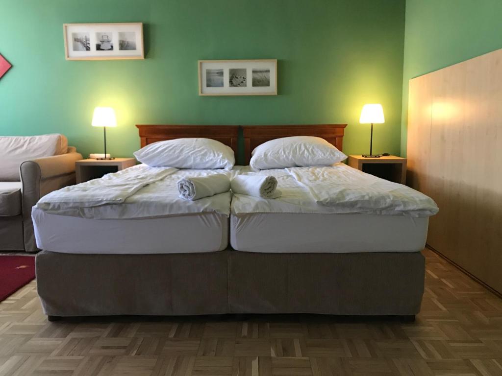a bedroom with a bed with two pillows on it at Budapest Flat Rent in Budapest