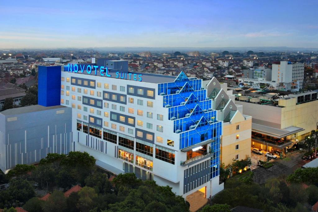 a building with blue stairs on the side of it at Novotel Suites Yogyakarta Malioboro in Yogyakarta