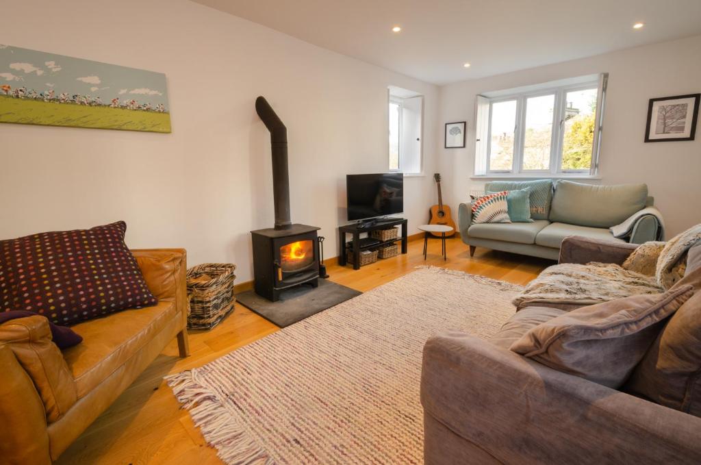 a living room with a couch and a wood stove at High Barn, Ambleside in Ambleside