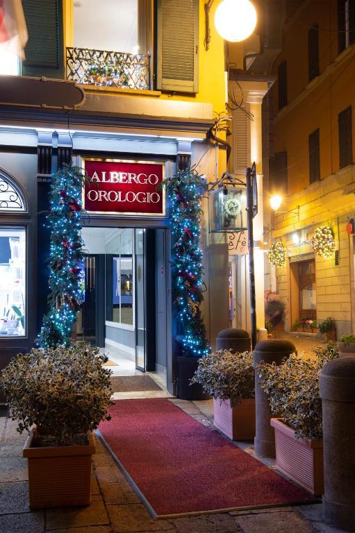 a store with christmasreens and a sign on a street at Art Hotel Orologio in Bologna