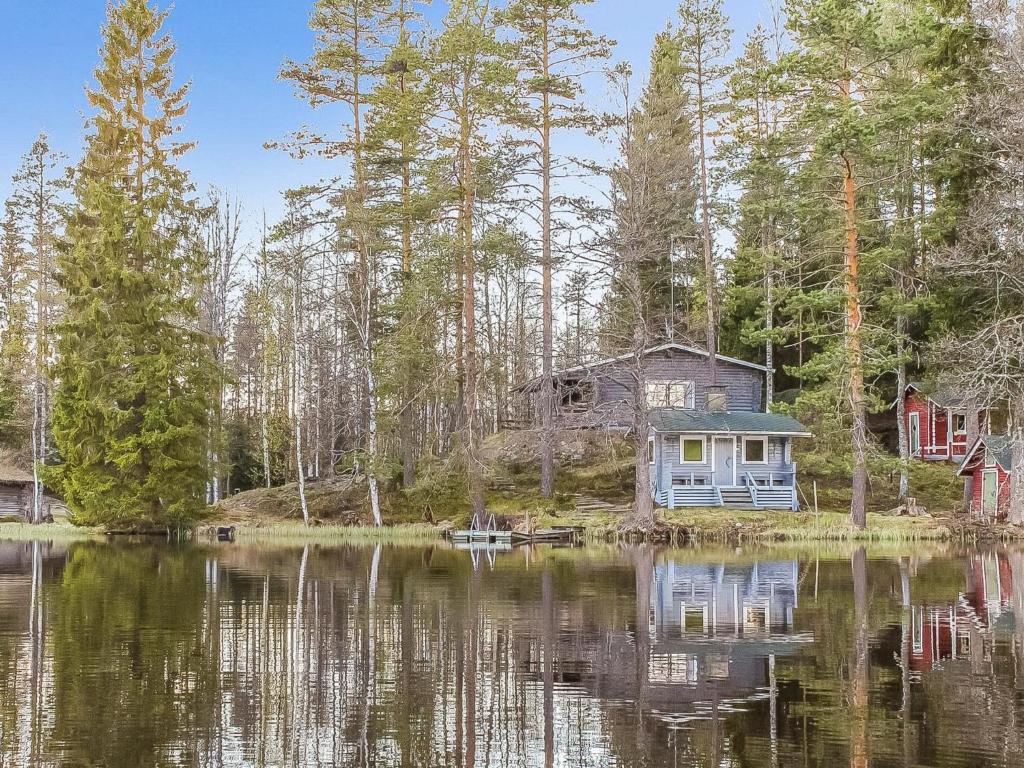 ein Haus am Ufer eines Wasserkörpers in der Unterkunft Holiday Home Heinälampi by Interhome in Laakkii