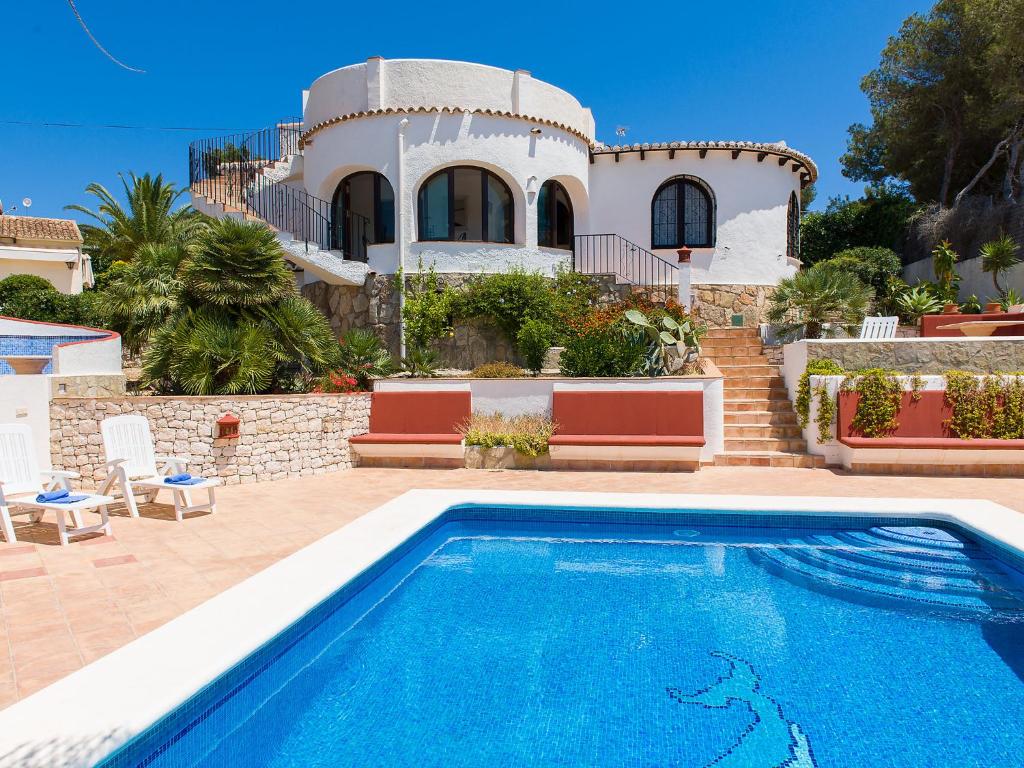 a villa with a swimming pool in front of a house at Villa Tana by Interhome in Balcon del Mar