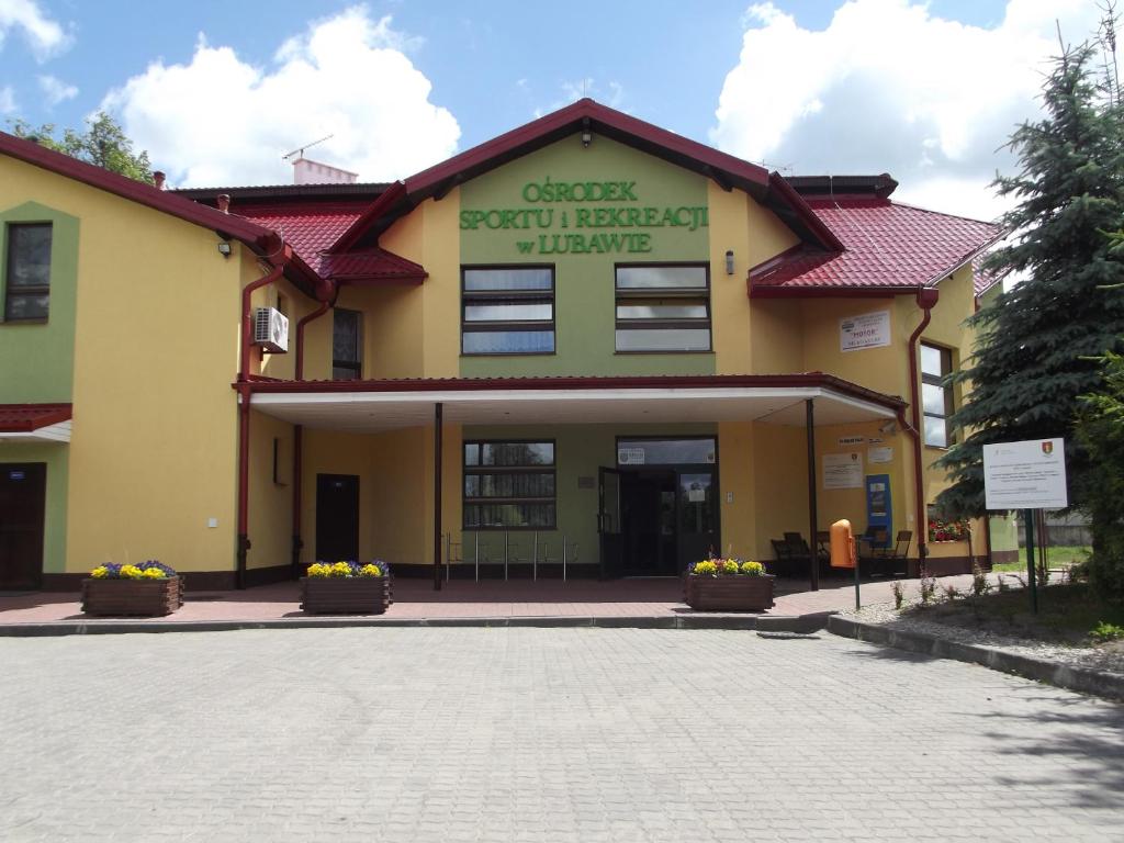 a building with a sign on the front of it at Hotelik OSiR Lubawa in Lubawa