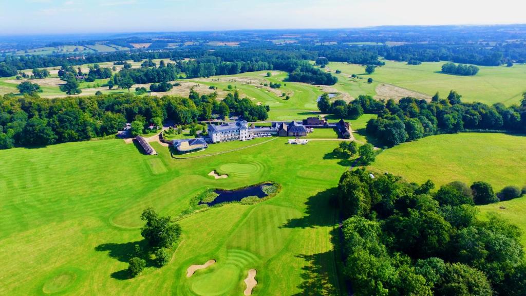 an aerial view of a house on a green field at Bowood Hotel, Spa, and Golf Resort in Chippenham