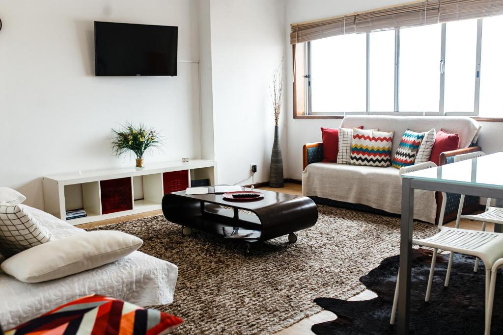 a living room with a couch and a table at Aveiro City Center in Aveiro