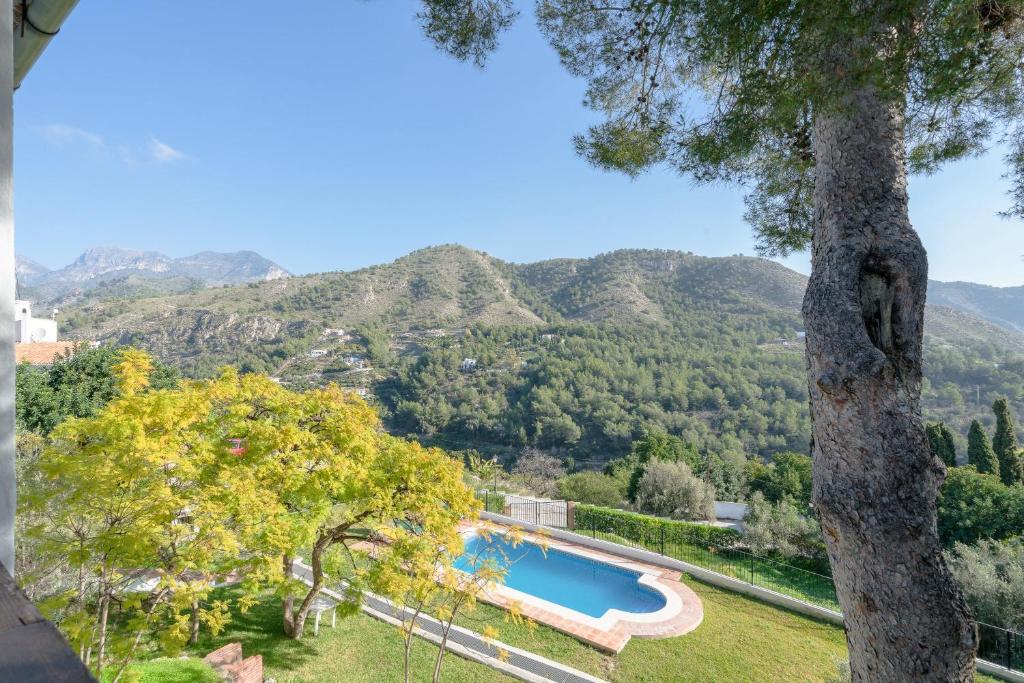 a view of a swimming pool with mountains in the background at Casa Peregrino in Frigiliana